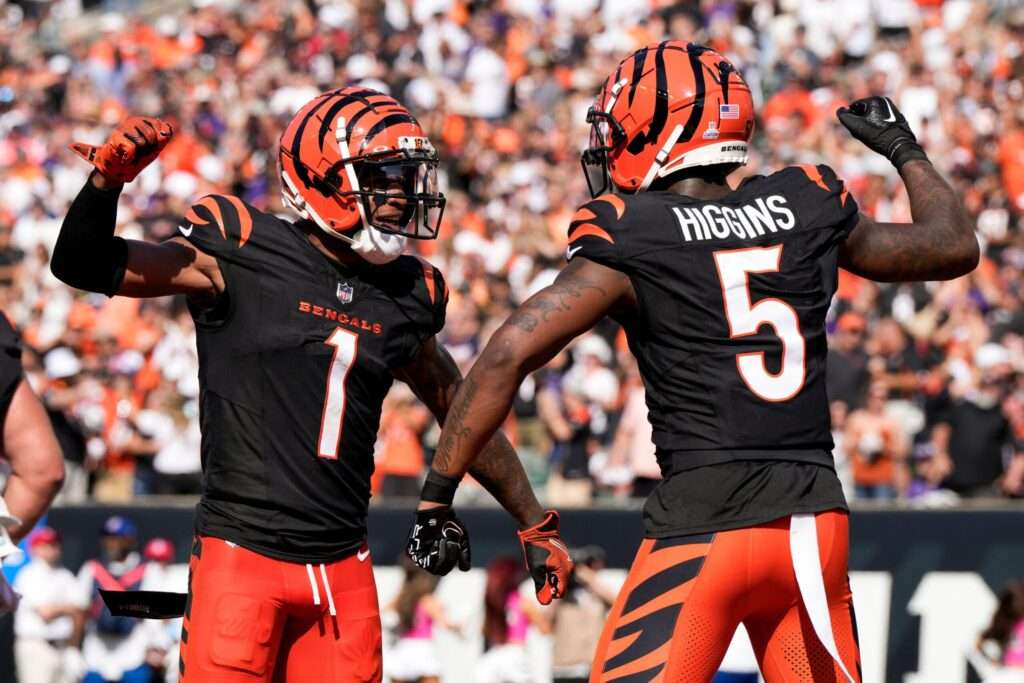 Cincinnati Bengals wide receiver Tee Higgins (5) reacts with teammate Ja'Marr Chase (1) after catching a touchdown pass against the Baltimore Ravens during the second half of an NFL football game, Sunday, Oct. 6, 2024, in Cincinnati. (AP Photo/Jeff Dean)