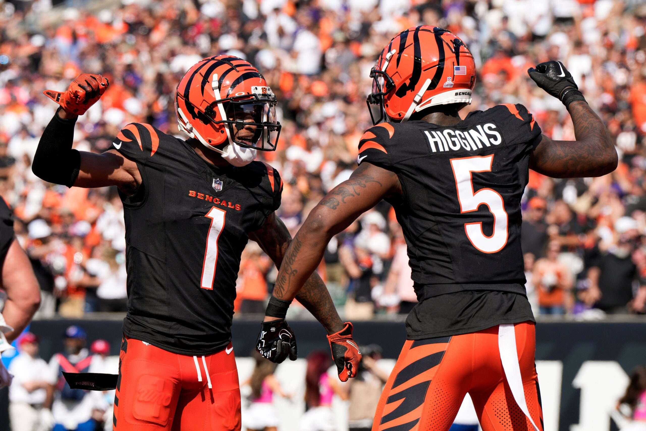 Cincinnati Bengals wide receiver Tee Higgins (5) reacts with teammate Ja'Marr Chase (1) after catching a touchdown pass against the Baltimore Ravens during the second half of an NFL football game, Sunday, Oct. 6, 2024, in Cincinnati. (AP Photo/Jeff Dean)
